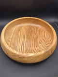 Hand-turned Donegal olive ash wood bowl front view on wooden surface
